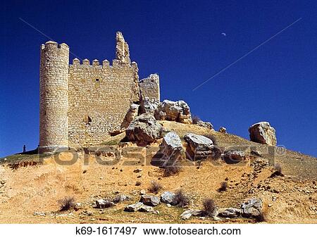 At the eastern end of the Senorio de Molina, in the Spanish province of Guadalajara lies this small ruined castle in a village by the same name Embid Castle is built on top of a hill near the edge of the village It's a typical mountain castle with dwell View Large Photo Image Stock Photo - At the eastern end of the Senorio de Molina, in the Spanish province of Guadalajara lies this small ruined castle in a village by the same name Embid Castle is built on top of a hill near the edge of the village It's a typical mountain castle with dwell. Fotosearch