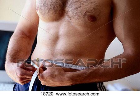 Athletic man measuring his waist View Large Photo Image Stock Image - Athletic man measuring his waist. Fotosearch