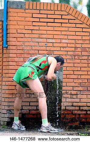 Athletics Athlete drinking water in a competition of the Madrid athletics View Large Photo Image Stock Photo - Athletics Athlete drinking water in a competition of the Madrid athletics. Fotosearch