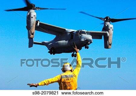 ATLANTIC OCEAN (Sept. 9, 2011) Aviation Boatswain's Mate 3rd Class Eddie Berryhill directs a V-22 Osprey on its final approach aboard the amphibious assault ship USS Wasp (LHD 1). Wasp is underway conducting sea trials. View Large Photo Image Stock Image - ATLANTIC OCEAN (Sept. 9, 2011) Aviation Boatswain's Mate 3rd Class Eddie Berryhill directs a V-22 Osprey on its final approach aboard the amphibious assault ship USS Wasp (LHD 1). Wasp is underway conducting sea trials.. Fotosearch