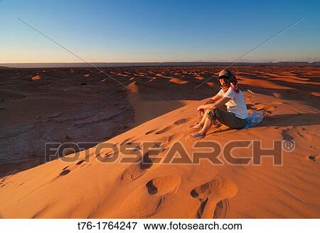 Stock Photo - atop a sand dune in the Sahara Desert at Erg Chigaga, Morocco. Fotosearch