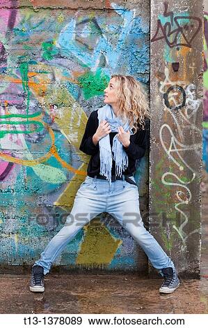 Attractive adult girl before a colorful wall View Large Photo Image Stock Photo - Attractive adult girl before a colorful wall. Fotosearch