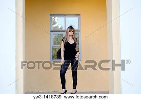 Stock Photo - Attractive blond 20-25 years girl against ancient window. Fotosearch