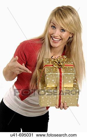 Stock Image - Attractive blond holding presents. Fotosearch