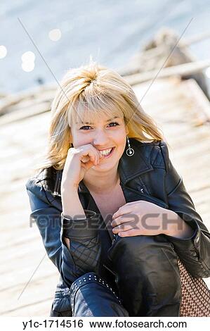 Attractive blonde woman on a pier View Large Photo Image Stock Photograph - Attractive blonde woman on a pier. Fotosearch