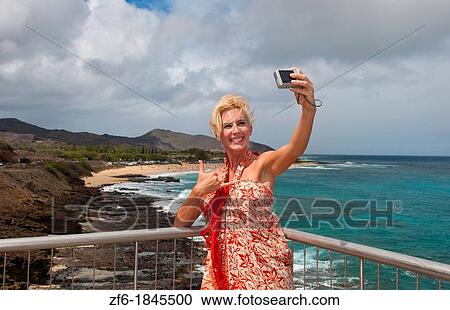 Attractive blonde woman tourist taking picture near Halona Blow Hole in East Oahu near Honolulu Hawaii View Large Photo Image Stock Image - Attractive blonde woman tourist taking picture near Halona Blow Hole in East Oahu near Honolulu Hawaii. Fotosearch