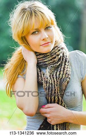 Stock Photograph - Attractive blonde young woman in the park. Fotosearch