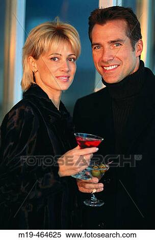 Stock Photography - attractive couple with cocktails. Fotosearch