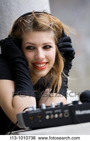 Stock Photo - Attractive DJ young woman happy. Fotosearch