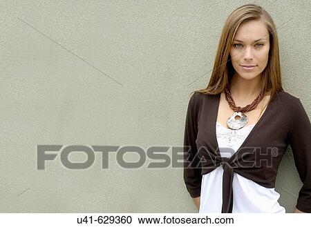 Attractive female 26 years old leaning on textured wall wide shot looking to camera View Large Photo Image Stock Image - Attractive female 26 years old leaning on textured wall wide shot looking to camera. Fotosearch