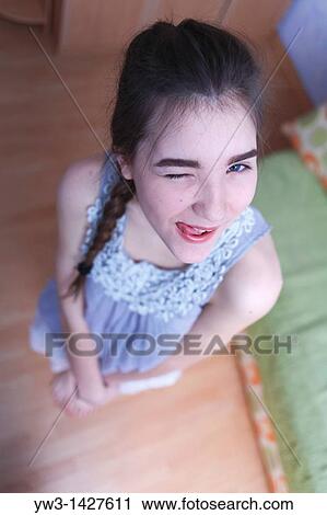 Attractive funny blond with braid women posing in a room View Large Photo Image Stock Image - Attractive funny blond with braid women posing in a room. Fotosearch
