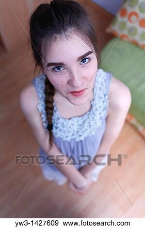 Attractive funny blond with braid women posing in a room View Large Photo Image Stock Photo - Attractive funny blond with braid women posing in a room. Fotosearch