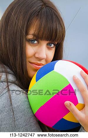 Attractive girl and a colorful ball View Large Photo Image Stock Photo - Attractive girl and a colorful ball. Fotosearch