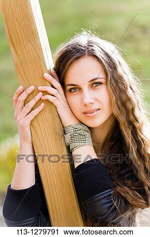 Stock Image - Attractive girl portrait with a long curly hair. Fotosearch