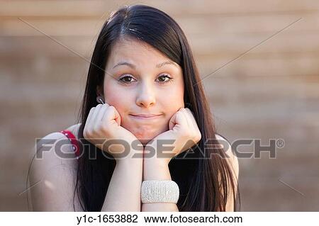 Stock Image - Attractive girl regretful portrait. Fotosearch