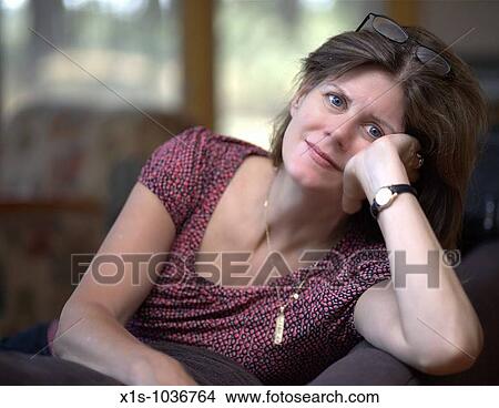 Attractive middle aged woman looks at the camera View Large Photo Image Picture - Attractive middle aged woman looks at the camera. Fotosearch