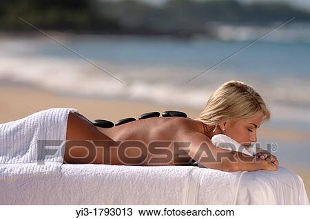 Attractive, shapely woman enjoys massage stones at the beach at Makena, Maui, Hawaii View Large Photo Image Stock Image - Attractive, shapely woman enjoys massage stones at the beach at Makena, Maui, Hawaii. Fotosearch