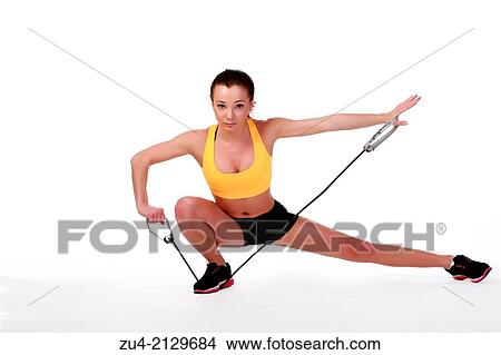 Attractive slim female model exercising. View Large Photo Image Picture - Attractive slim female model exercising.. Fotosearch