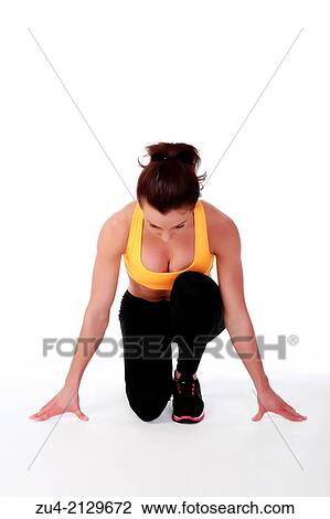 Stock Image - Attractive slim female model exercising.. Fotosearch