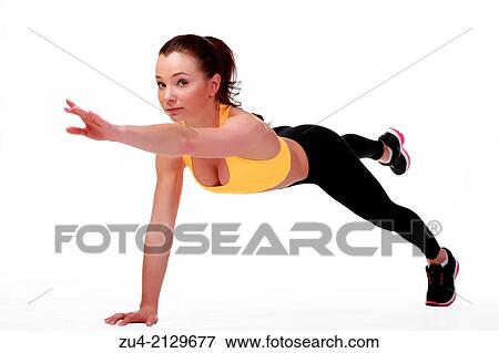Attractive slim female model exercising. View Large Photo Image Stock Photo - Attractive slim female model exercising.. Fotosearch