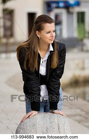 Stock Image - Attractive teenage girl is resting and waiting. Fotosearch