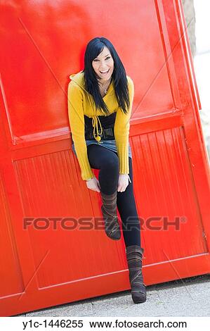 Attractive woman caught putting on a boot View Large Photo Image Stock Photography - Attractive woman caught putting on a boot. Fotosearch