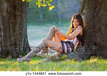 Attractive woman is resting by the tree View Large Photo Image Stock Image - Attractive woman is resting by the tree. Fotosearch