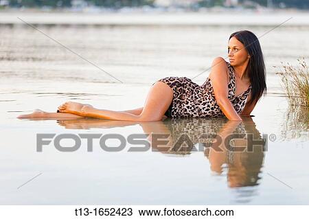 Attractive woman lying in a shallow water View Large Photo Image Stock Image - Attractive woman lying in a shallow water. Fotosearch
