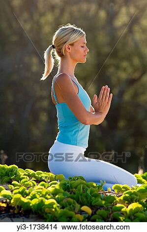 Picture - Attractive woman practices yoga at Makena, Maui, Hawaii. Fotosearch