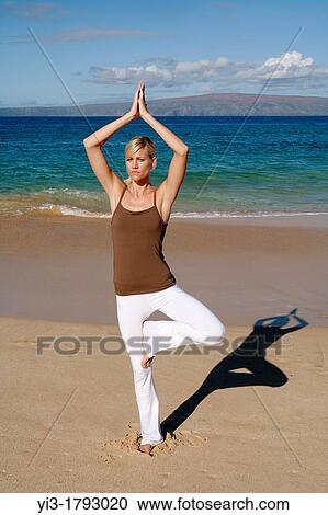 Attractive woman practices yoga at Makena, Maui, Hawaii View Large Photo Image Stock Image - Attractive woman practices yoga at Makena, Maui, Hawaii. Fotosearch