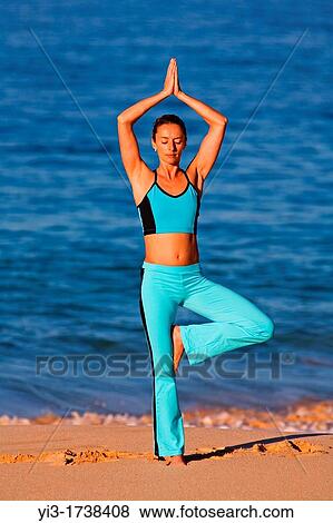 Attractive woman practices yoga at Makena, Maui, Hawaii View Large Photo Image Stock Photo - Attractive woman practices yoga at Makena, Maui, Hawaii. Fotosearch