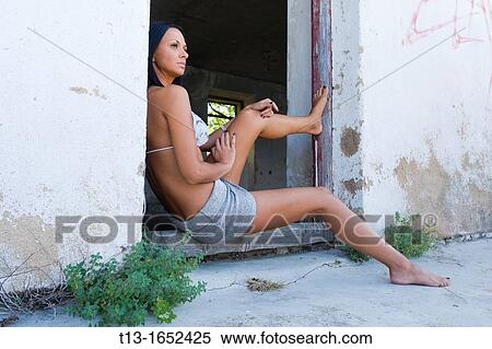 Attractive woman waiting on a porch of a derelict house View Large Photo Image Stock Photography - Attractive woman waiting on a porch of a derelict house. Fotosearch