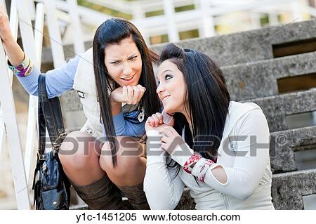 Stock Photography - Attractive women and an incoming mobile phone call. Fotosearch