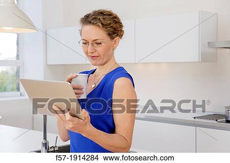 Picture - Attractive young businesswoman preparing to go to work. Fotosearch