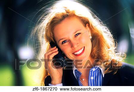 Attractive young businesswoman using cellular phone View Large Photo Image Stock Image - Attractive young businesswoman using cellular phone. Fotosearch