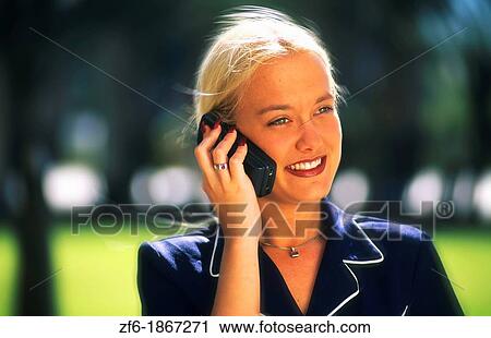 Attractive young businesswoman using cellular phone View Large Photo Image Stock Image - Attractive young businesswoman using cellular phone. Fotosearch