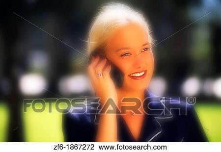 Attractive young businesswoman using cellular phone View Large Photo Image Stock Image - Attractive young businesswoman using cellular phone. Fotosearch