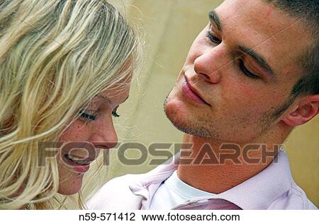 Attractive young couple flirting View Large Photo Image Stock Image - Attractive young couple flirting. Fotosearch