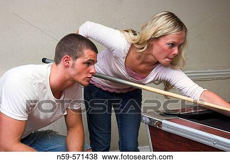 Attractive young couple having fun playing pool View Large Photo Image Stock Photo - Attractive young couple having fun playing pool. Fotosearch