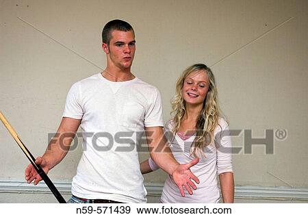 Attractive young couple having fun playing pool View Large Photo Image Stock Photo - Attractive young couple having fun playing pool. Fotosearch
