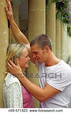 Attractive young couple laughing together during a tender moment. View Large Photo Image Stock Image - Attractive young couple laughing together during a tender moment.. Fotosearch