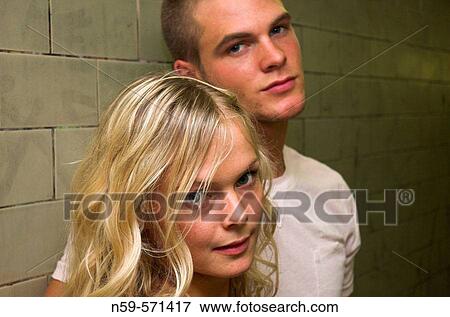 Attractive young couple looking at the camera. Focus on the girl. View Large Photo Image Stock Photo - Attractive young couple looking at the camera. Focus on the girl.. Fotosearch