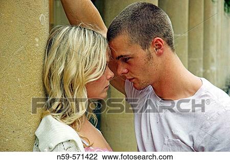 Attractive young couple looking into each other's eyes. View Large Photo Image Stock Image - Attractive young couple looking into each other's eyes.. Fotosearch