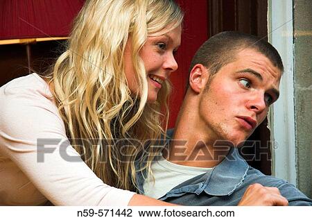 Attractive young couple looking through a window. View Large Photo Image Stock Image - Attractive young couple looking through a window.. Fotosearch