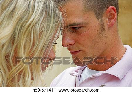 Attractive young couple physically close but struggling to communicate. View Large Photo Image Stock Image - Attractive young couple physically close but struggling to communicate.. Fotosearch