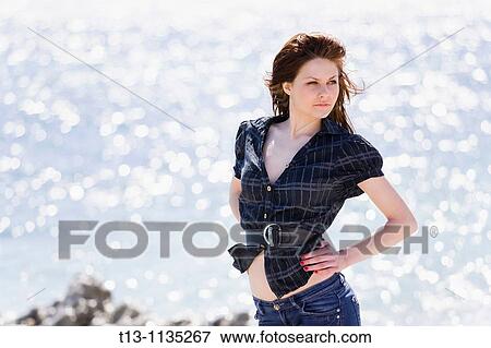 Attractive young woman against a glaring sunlight View Large Photo Image Stock Photo - Attractive young woman against a glaring sunlight. Fotosearch