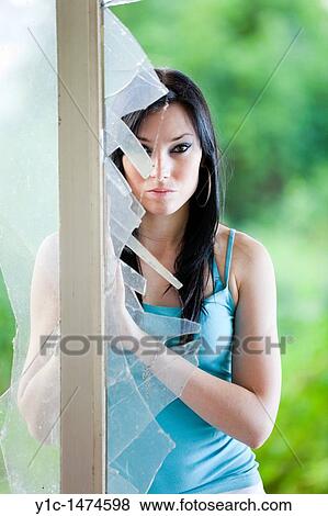 Stock Photo - Attractive young woman and a broken glass. Fotosearch