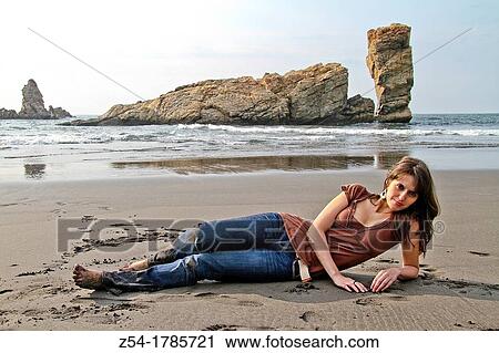 Stock Image - Attractive young Woman at El Sabl? n beach, Asturias, Spain. Fotosearch
