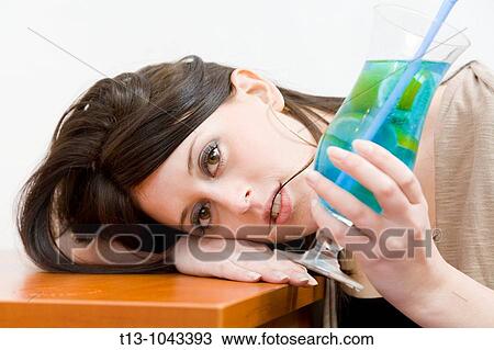 Attractive young woman drunk with a cocktail glass in hand View Large Photo Image Stock Image - Attractive young woman drunk with a cocktail glass in hand. Fotosearch