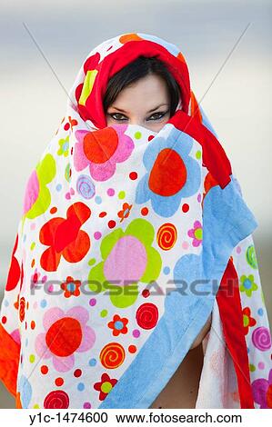 Attractive young woman enveloped with a colorful towel View Large Photo Image Stock Image - Attractive young woman enveloped with a colorful towel. Fotosearch